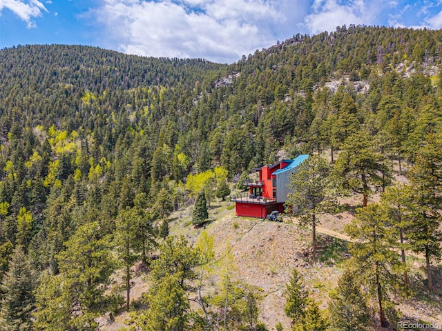 5896 Peregrine Trl, Golden, CO 80403 - view of subject property featuring a heavily wooded area and a mountainous background