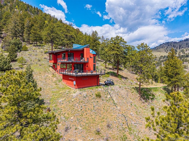 5896 Peregrine Trl, Golden, CO 80403 - rear view of house with a wooded view