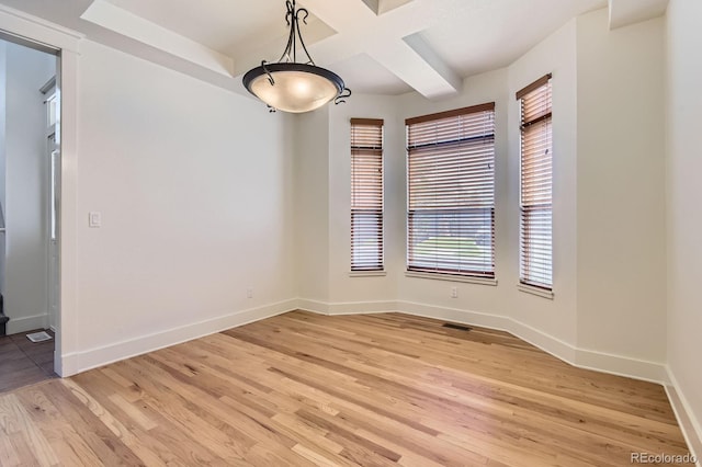 19259 E Caspian Pl, Aurora, CO 80013 - empty room with light wood-type flooring, coffered ceiling, and beamed ceiling