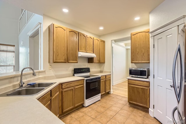 19259 E Caspian Pl, Aurora, CO 80013 - kitchen featuring white electric range, under cabinet range hood, stainless steel microwave, refrigerator, and light tile patterned floors
