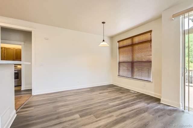 19259 E Caspian Pl, Aurora, CO 80013 - unfurnished dining area with wood finished floors and baseboards