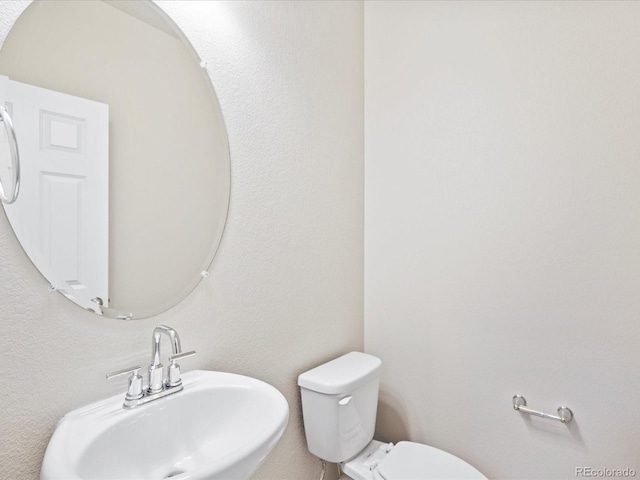 bathroom featuring toilet and sink