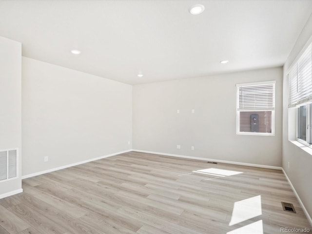 empty room with light hardwood / wood-style floors