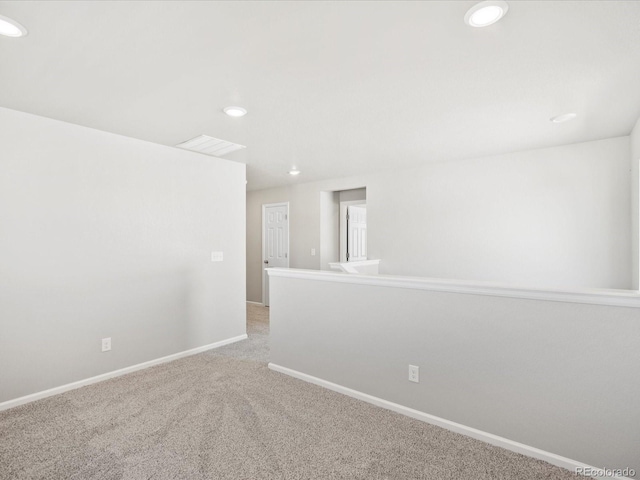 spare room featuring light colored carpet