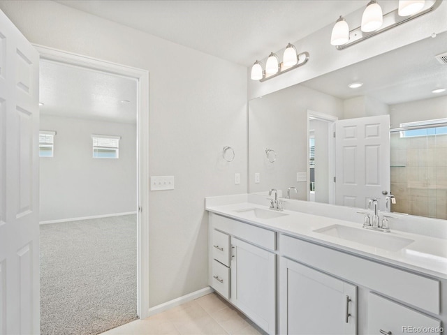 bathroom featuring a shower with door and vanity