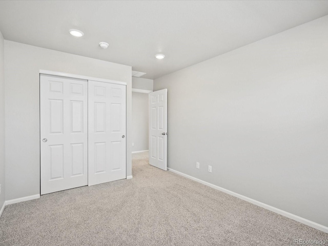 unfurnished bedroom featuring carpet floors and a closet