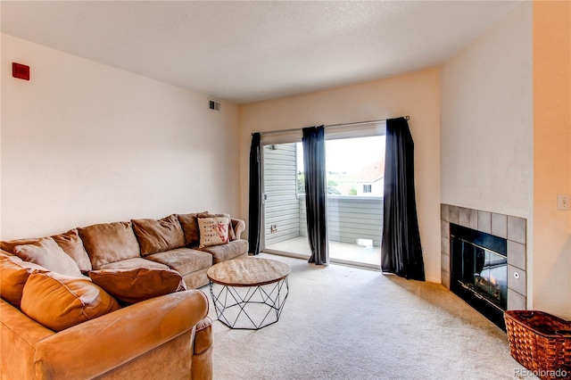 908 S Yampa St Unit 208, Aurora, CO 80017 - carpeted living room with a tiled fireplace