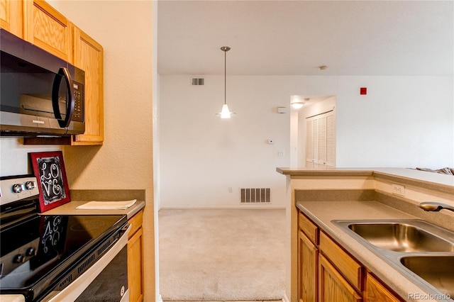 908 S Yampa St Unit 208, Aurora, CO 80017 - kitchen featuring range with electric cooktop, a sink, carpet flooring, hanging light fixtures, and brown cabinets