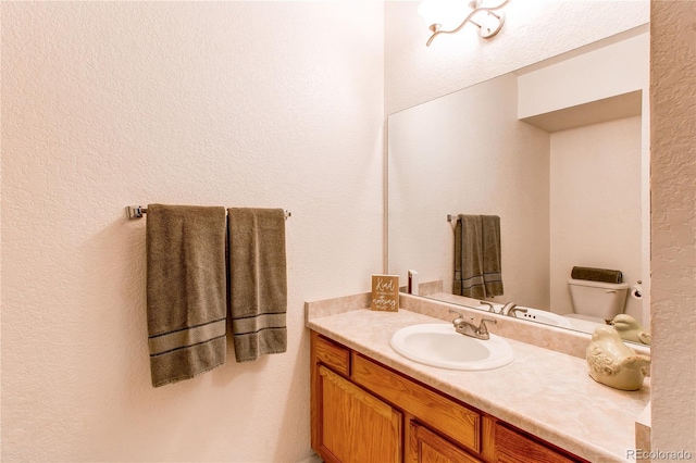 908 S Yampa St Unit 208, Aurora, CO 80017 - bathroom with vanity, a textured wall, and toilet