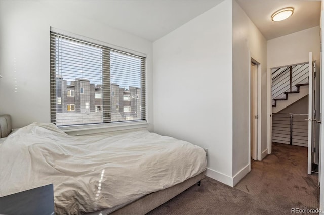 carpeted bedroom with lofted ceiling and a closet