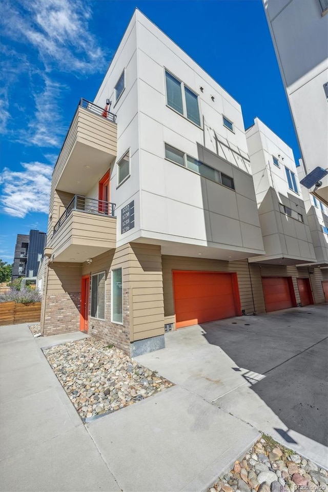 view of front of home featuring a balcony and a garage