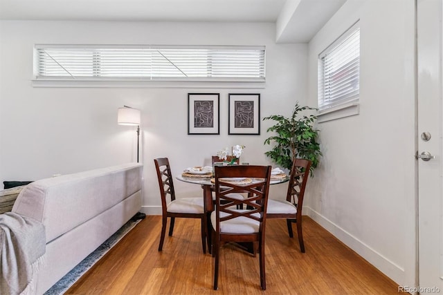 1216 Perry St, Denver, CO 80204 - dining room featuring wood finished floors and plenty of natural light