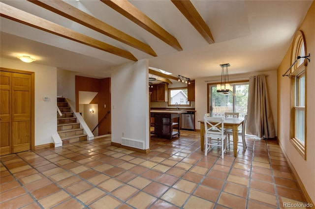 3722 Monterey Pl, Boulder, CO 80301 - dining area with stairs, light tile patterned floors, beam ceiling, and a chandelier