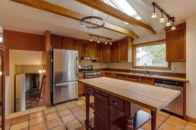 3722 Monterey Pl, Boulder, CO 80301 - kitchen with stainless steel appliances, wooden counters, rail lighting, under cabinet range hood, and light tile patterned floors