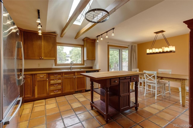 3722 Monterey Pl, Boulder, CO 80301 - kitchen with freestanding refrigerator, dishwashing machine, track lighting, and healthy amount of natural light