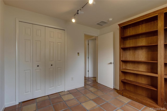 3722 Monterey Pl, Boulder, CO 80301 - unfurnished bedroom with rail lighting, a closet, and tile patterned flooring