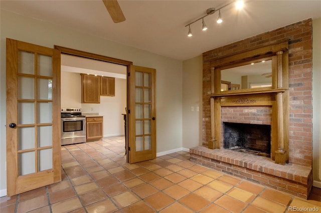 3722 Monterey Pl, Boulder, CO 80301 - unfurnished living room with a ceiling fan, a brick fireplace, light tile patterned flooring, and rail lighting