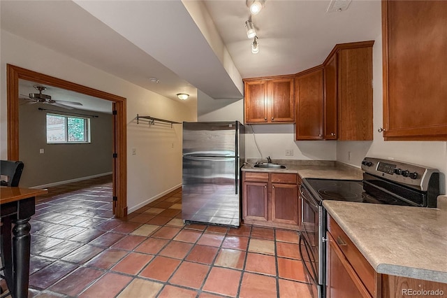 3722 Monterey Pl, Boulder, CO 80301 - kitchen with appliances with stainless steel finishes, brown cabinetry, light countertops, and ceiling fan