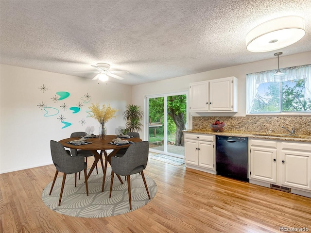 13561 W Alaska Pl, Lakewood, CO 80228 - dining space featuring a textured ceiling, ceiling fan, visible vents, and light wood-style floors
