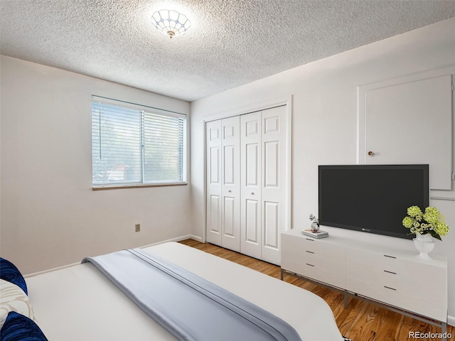 13561 W Alaska Pl, Lakewood, CO 80228 - bedroom with a closet, a textured ceiling, and wood finished floors