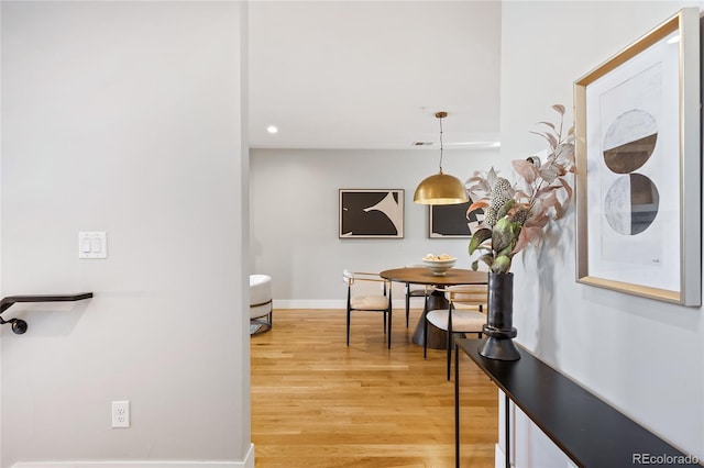 corridor featuring visible vents, recessed lighting, light wood-style floors, and baseboards