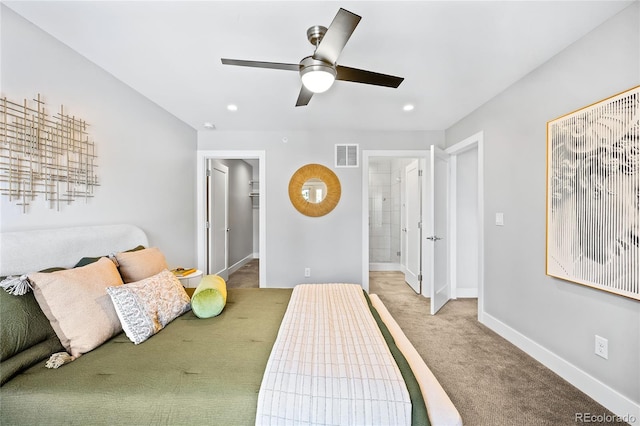 bedroom featuring visible vents, a walk in closet, connected bathroom, carpet, and baseboards