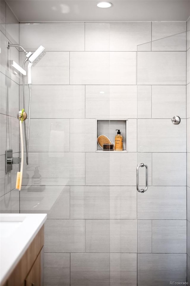 full bath featuring vanity and a shower stall