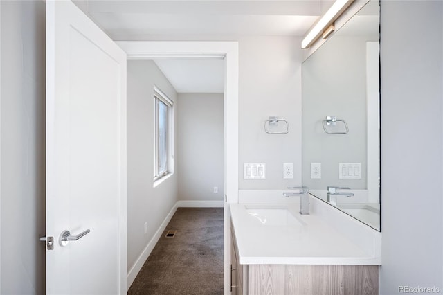 bathroom with visible vents, vanity, and baseboards