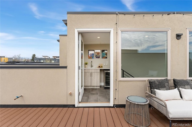 wooden deck with wine cooler and a sink