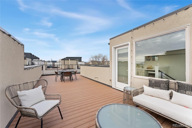 deck with an outdoor living space and outdoor dining area