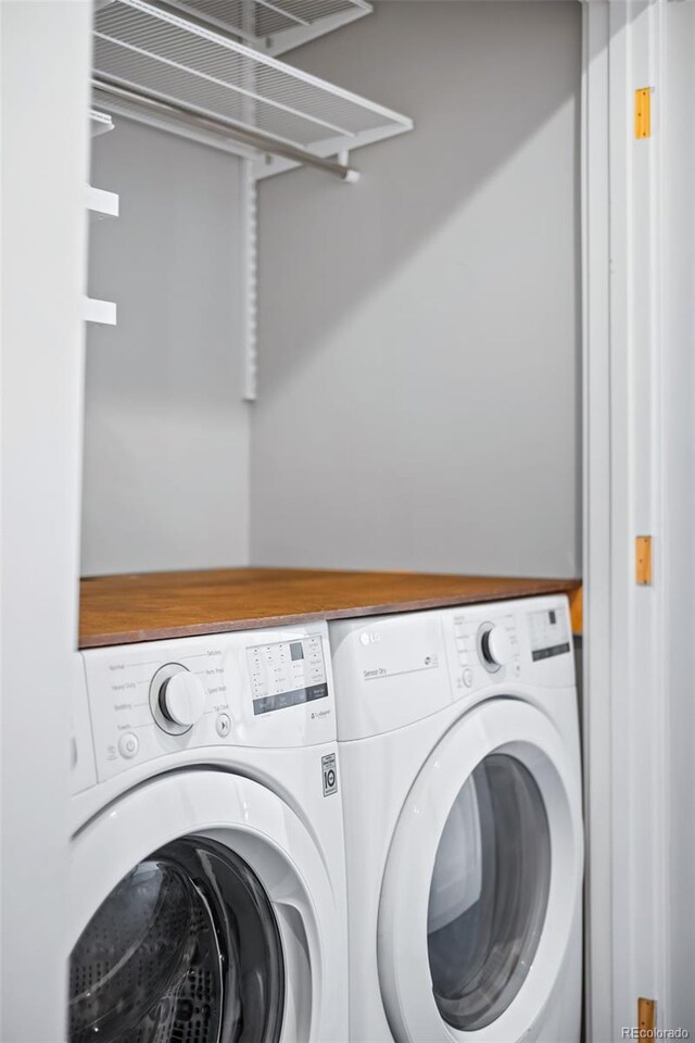 laundry area with washer and clothes dryer and laundry area