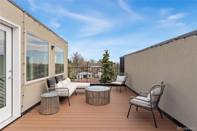 wooden deck with an outdoor living space