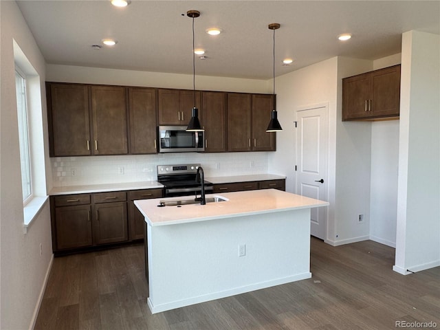 2142 S Irvington St, Aurora, CO 80018 - kitchen with stainless steel appliances, a sink, dark wood-style flooring, baseboards, and decorative backsplash
