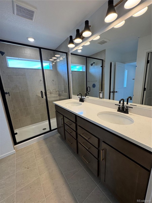 2142 S Irvington St, Aurora, CO 80018 - full bathroom with double vanity, a stall shower, and tile patterned flooring