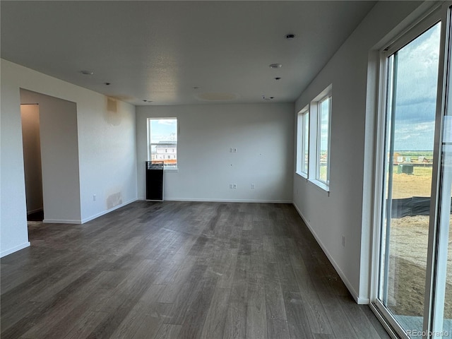 2142 S Irvington St, Aurora, CO 80018 - empty room with dark wood-style flooring and baseboards
