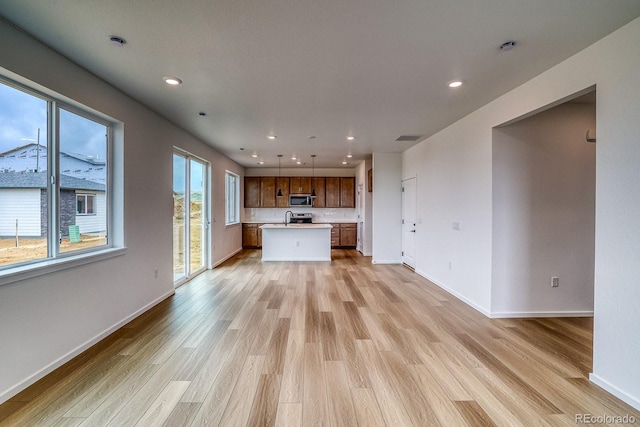 2142 S Irvington St, Aurora, CO 80018 - unfurnished living room featuring light wood-style flooring and recessed lighting