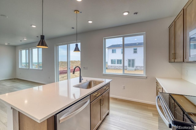 2142 S Irvington St, Aurora, CO 80018 - kitchen with appliances with stainless steel finishes, light wood-type flooring, light countertops, pendant lighting, and recessed lighting