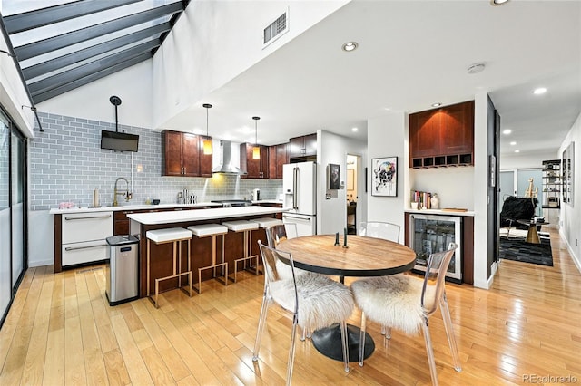 960 N Pennsylvania St Unit 6, Denver, CO 80203 - dining space with beverage cooler, light wood-type flooring, recessed lighting, and bar area
