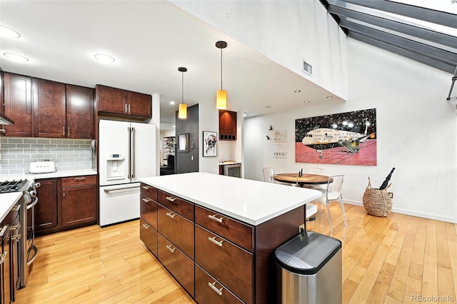 960 N Pennsylvania St Unit 6, Denver, CO 80203 - kitchen featuring high end white fridge, stainless steel range with gas cooktop, light wood-style flooring, a center island, and recessed lighting