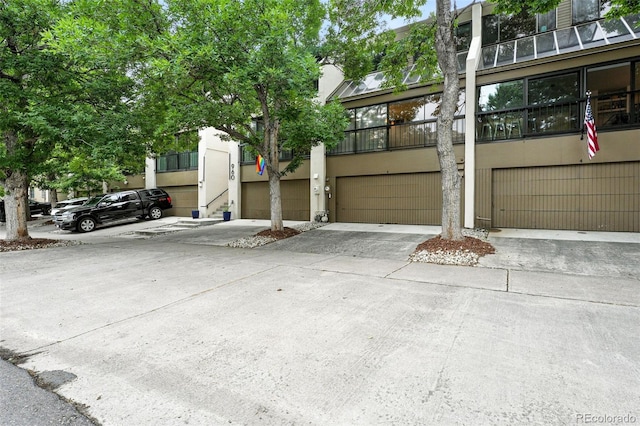 960 N Pennsylvania St Unit 6, Denver, CO 80203 - view of property with an attached garage, stucco siding, and driveway