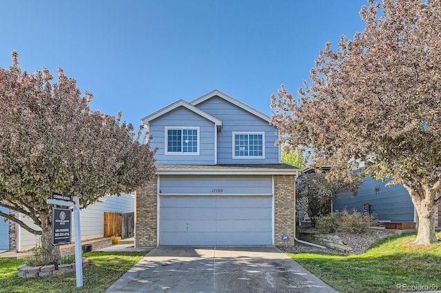 traditional-style home with brick siding, an attached garage, and concrete driveway