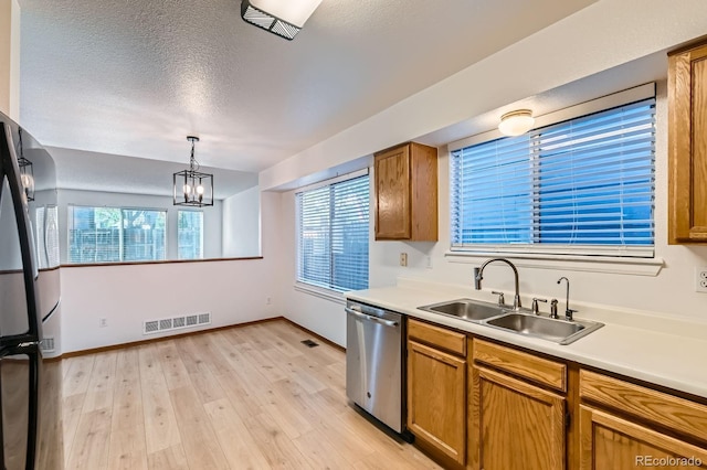 kitchen with visible vents, light wood-type flooring, dishwasher, a sink, and freestanding refrigerator