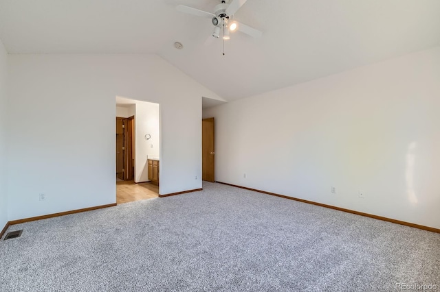 unfurnished bedroom featuring baseboards, light carpet, lofted ceiling, and visible vents