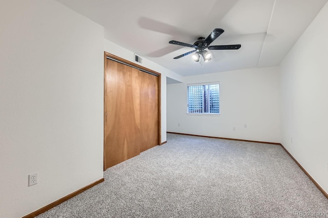 unfurnished bedroom with visible vents, carpet flooring, baseboards, and a closet