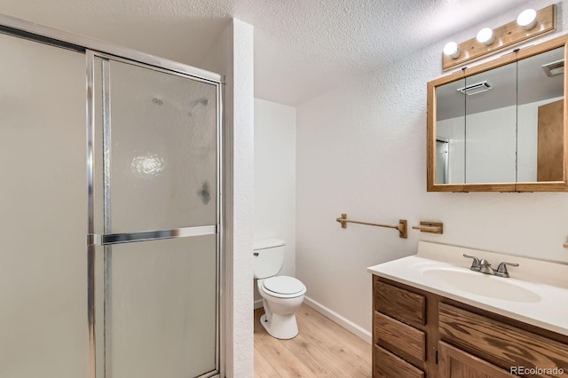 full bath with vanity, visible vents, wood finished floors, toilet, and a shower stall