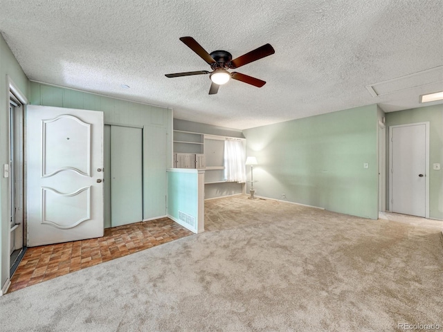 8730 E Roundtree Ave, Greenwood Village, CO 80111 - unfurnished living room featuring a ceiling fan, carpet floors, and a textured ceiling