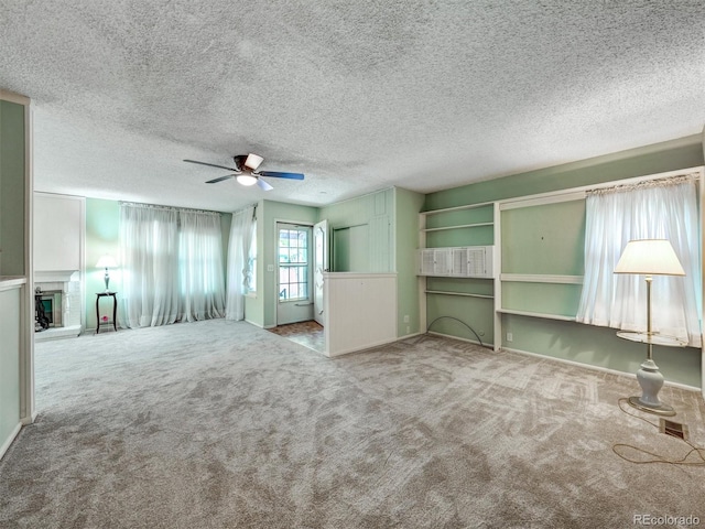 8730 E Roundtree Ave, Greenwood Village, CO 80111 - unfurnished living room featuring carpet flooring, ceiling fan, a fireplace with raised hearth, and baseboards
