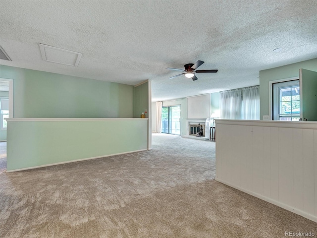 8730 E Roundtree Ave, Greenwood Village, CO 80111 - empty room featuring carpet flooring, plenty of natural light, ceiling fan, and a textured ceiling
