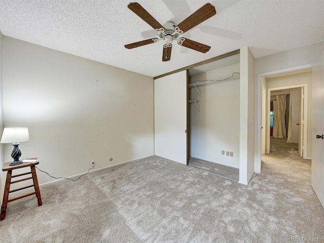 8730 E Roundtree Ave, Greenwood Village, CO 80111 - unfurnished bedroom featuring carpet flooring, a closet, a textured ceiling, and ceiling fan