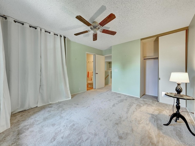 8730 E Roundtree Ave, Greenwood Village, CO 80111 - unfurnished bedroom with a textured ceiling, carpet floors, ensuite bathroom, ceiling fan, and a closet